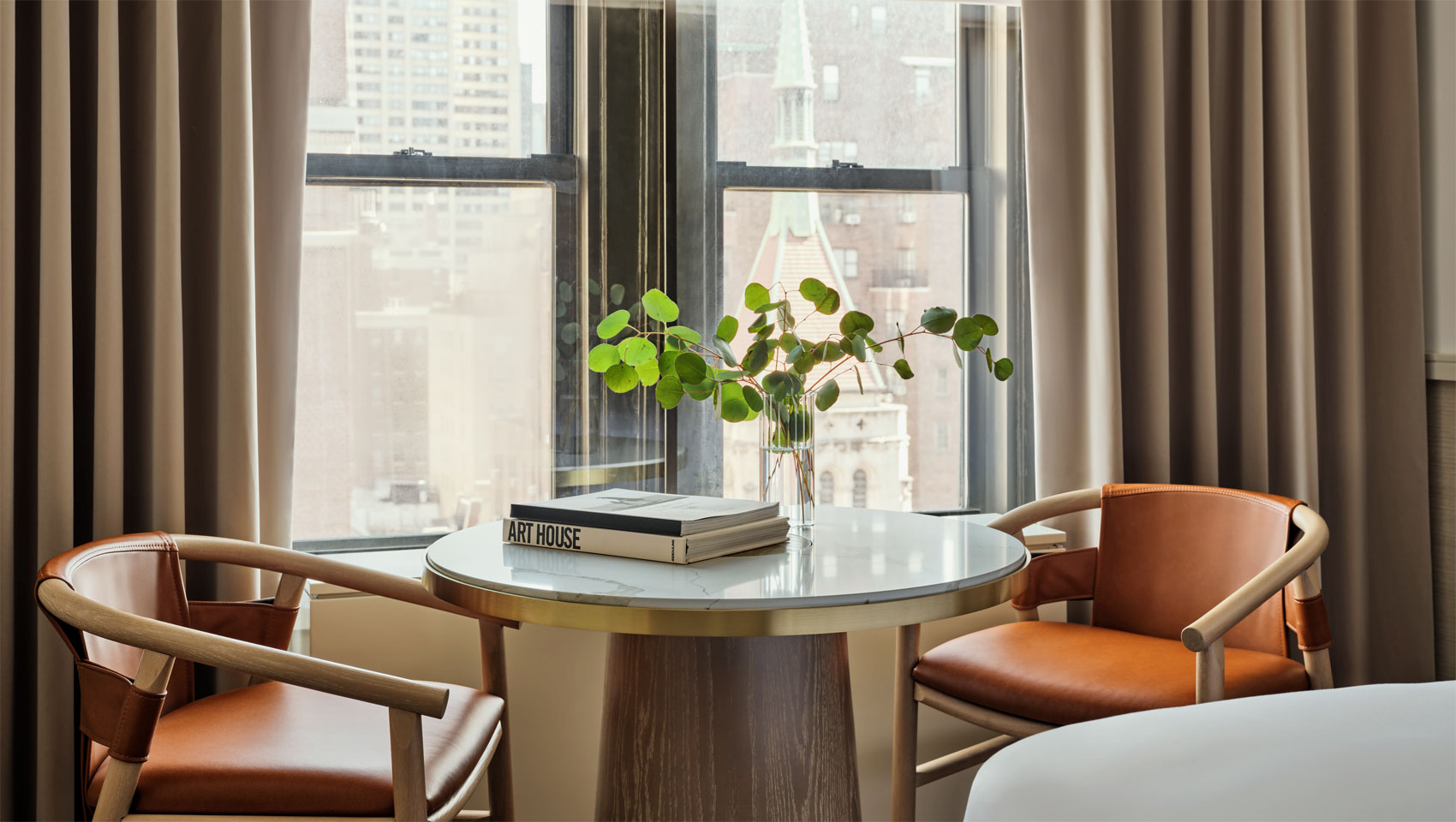 table and chairs in guestroom at 70 Park Ave