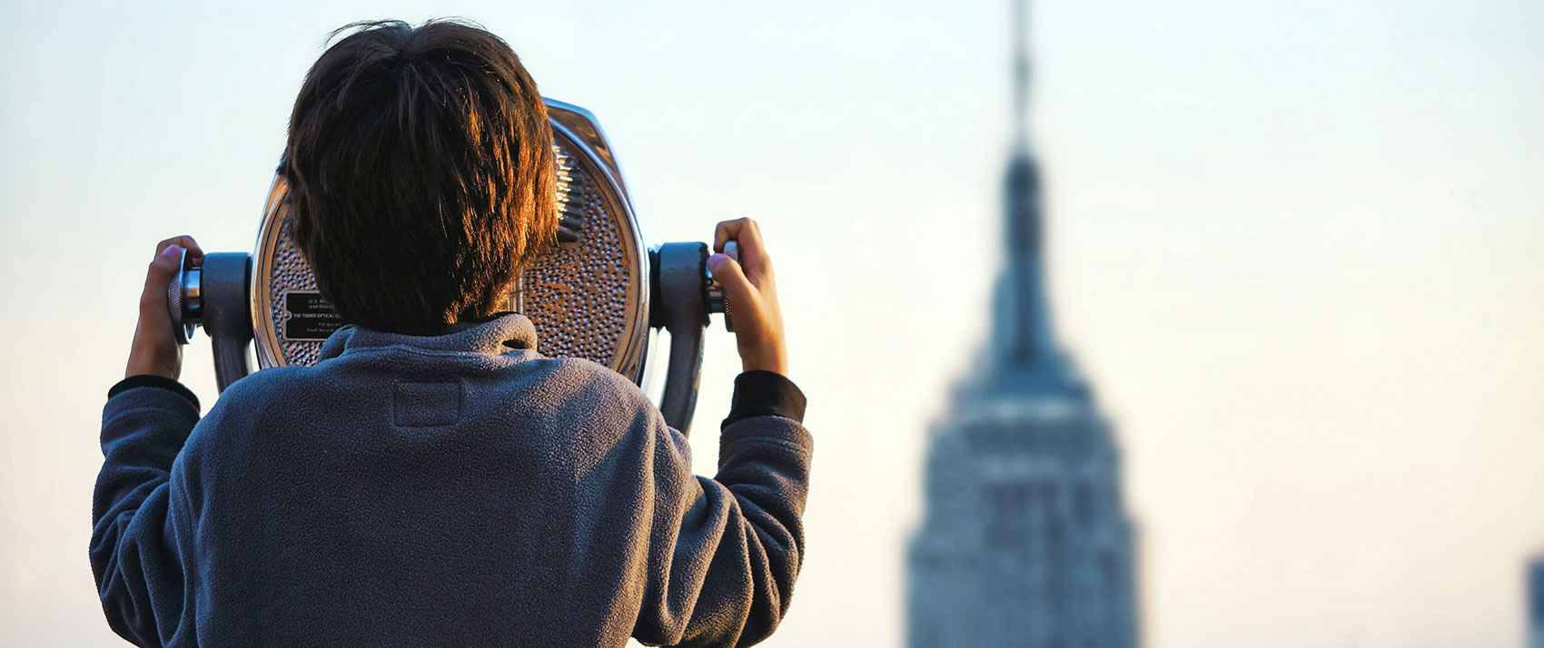 Kid looking out at top of the rock